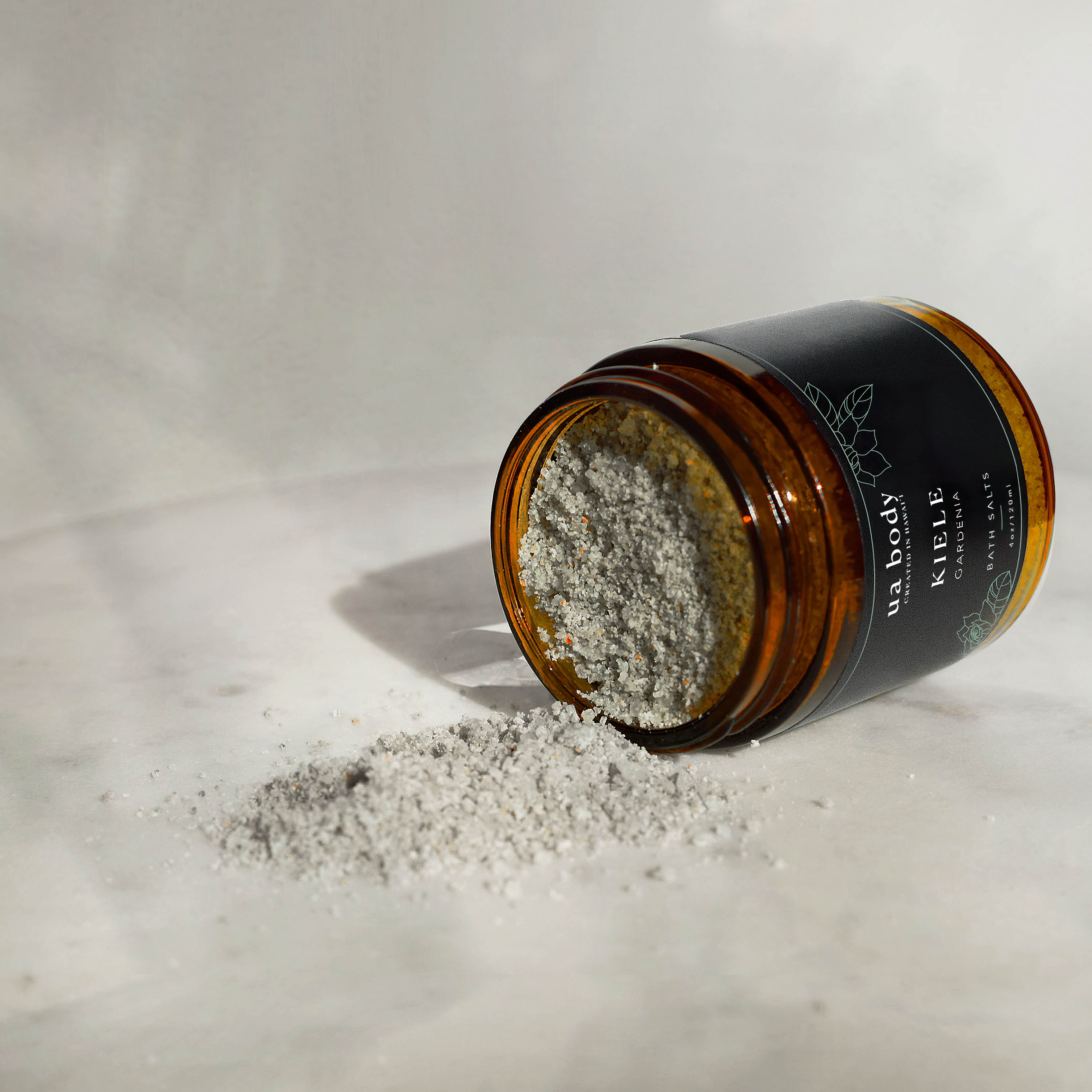 Kiele Bath Salts tipped in studio with bath salts pouring out