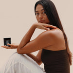 Woman posing and holding Botanical Cream