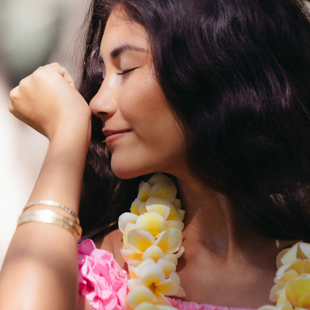 Hawaiian bath and body - woman smelling scented wrists