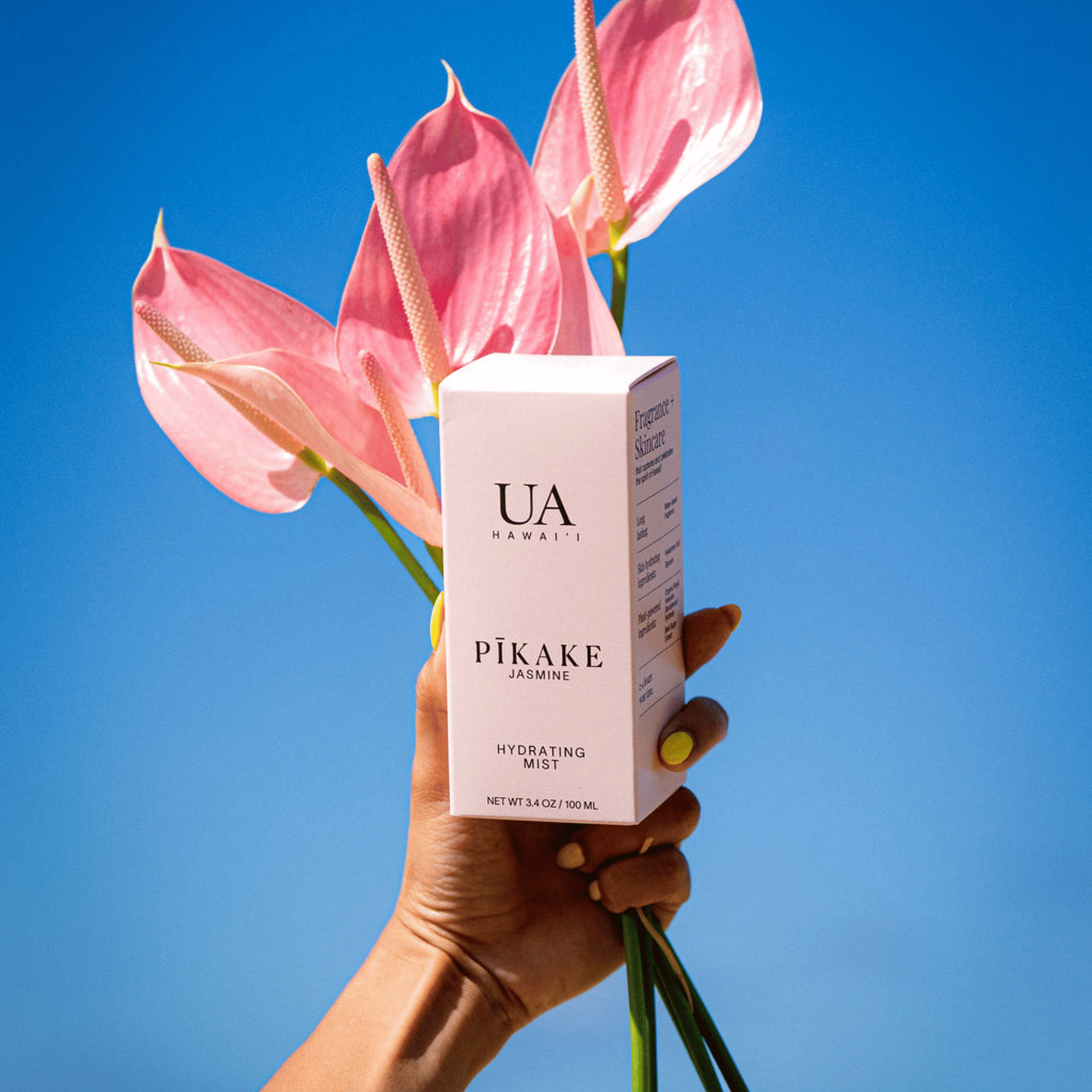 Holding Pikake Jasmine mist and flowers to the sky - Hawaiian Fragrances