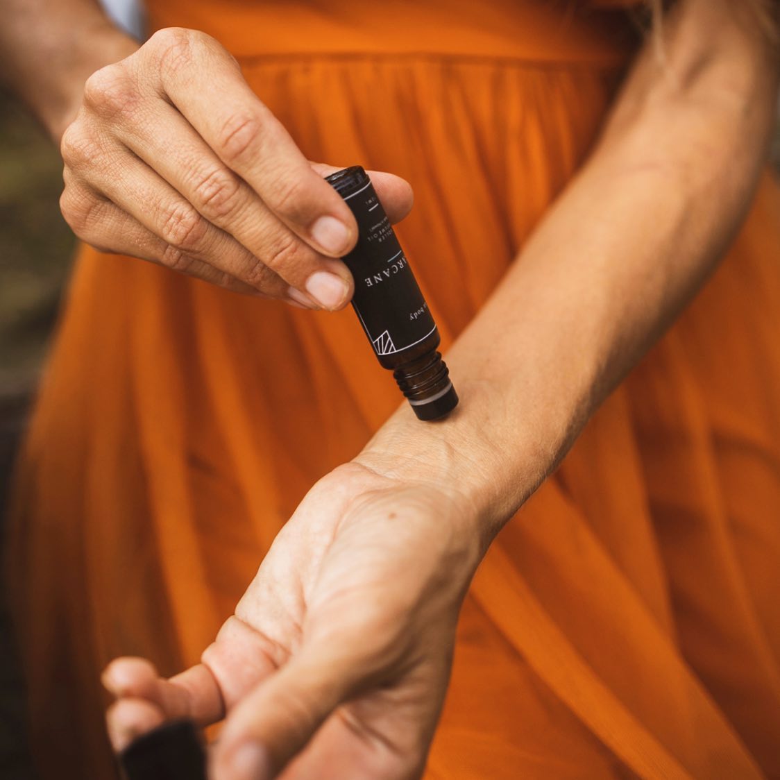 Woman Rubbing Roller Perfume on Wrist